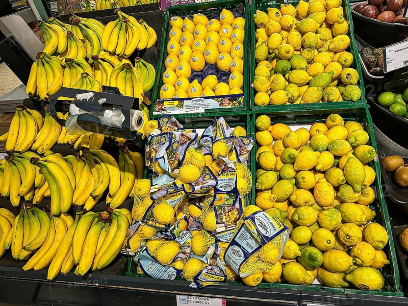 Fruit rack in a supermarket. The color yellow dominates here: bananas, lemons. Stuttgart, Baden-Württemberg, Germany