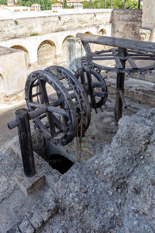 Old wooden machinery with wheels in an antique stone structure, Jerez