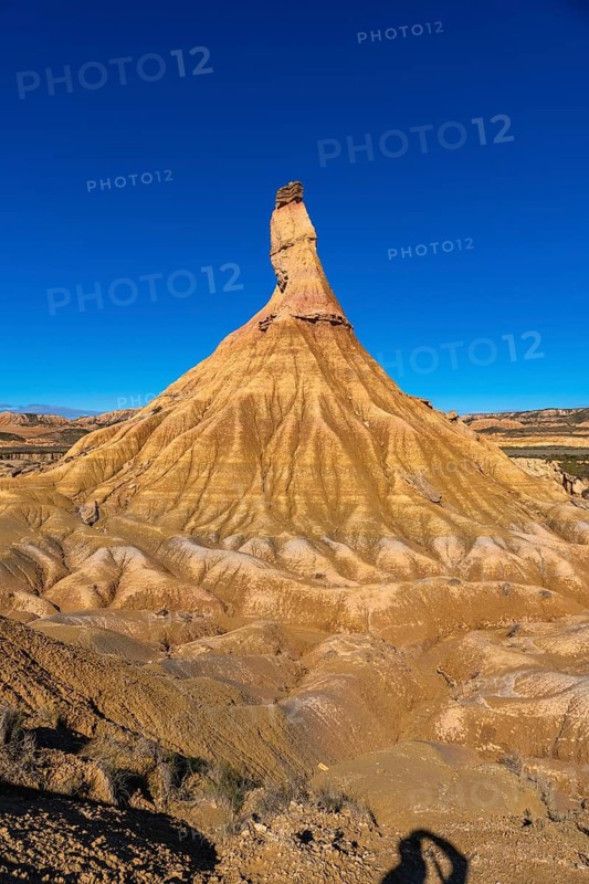 Majestic castildetierra rock formation rising from the eroded landscape of bardenas reales natural park in navarre, spain, under a vibrant blue sky