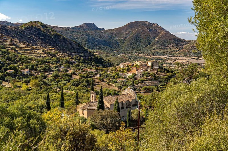 The Notre Dame de Lazio chapel and the village of Pgna seen from above, Balagne, Corsica, France