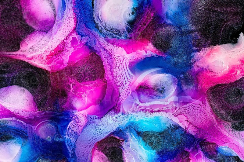 An abstract texture featuring vibrant pink and blue hues. The intricate patterns and swirling colors create a dynamic and galactic visual experience