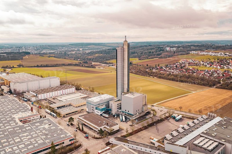 Tall tower building in an industrial and agricultural landscape with villages in the background, Schapfenmühle, Jungingen, Ulm, Germany