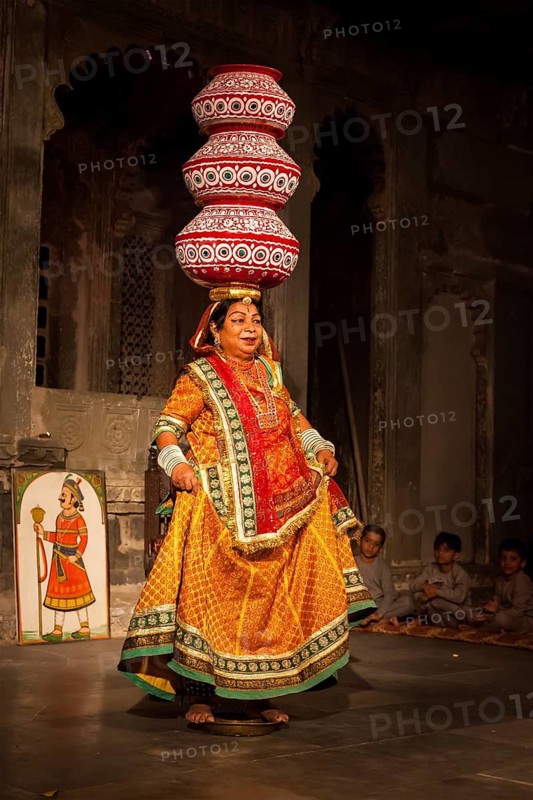 UDAIPUR, INDIA, NOVEMBER 24: Bhavai, famous folk dance of Rajasthan. Performer balances number pots as she dances on the rim of a brass thali (plate) . November 24, 2012 in Udaipur, Rajasthan, India