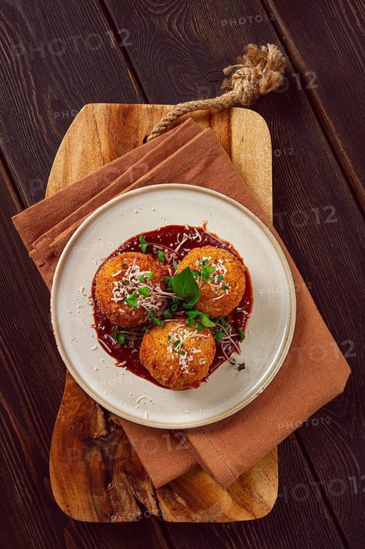 Crispy Arancini appetizer, with parmesan cheese and microgreens, plate, tomato sauce, homemade, no people
