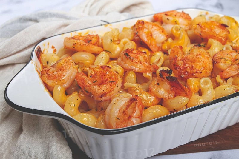 Pasta with shrimp and cheese, with a golden crust, cooked in a baking dish, homemade, no people