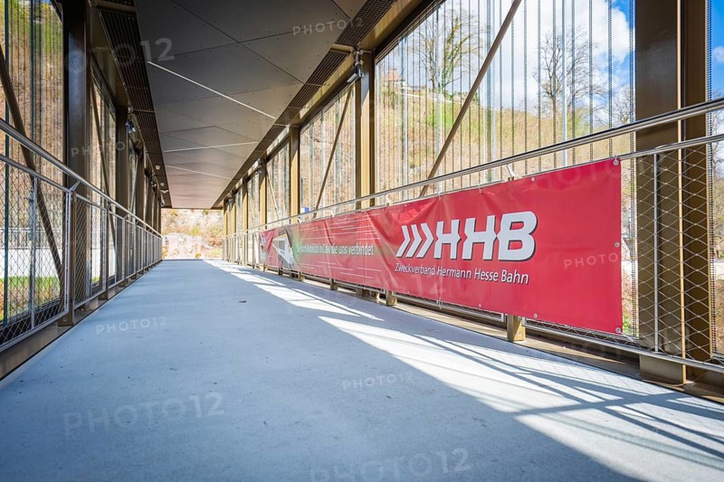 Sunny footbridge with modern architecture under blue sky, Hermann Hesse Bahn, ZOB, Calw, Germany