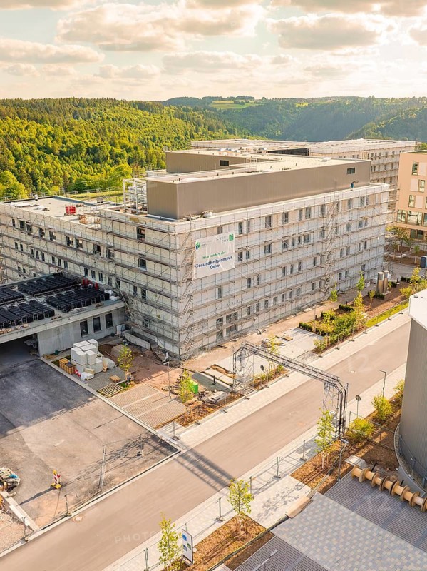 Large construction project in a green landscape with several building complexes and road accesses, construction of the new hospital health campus Calw, Germany