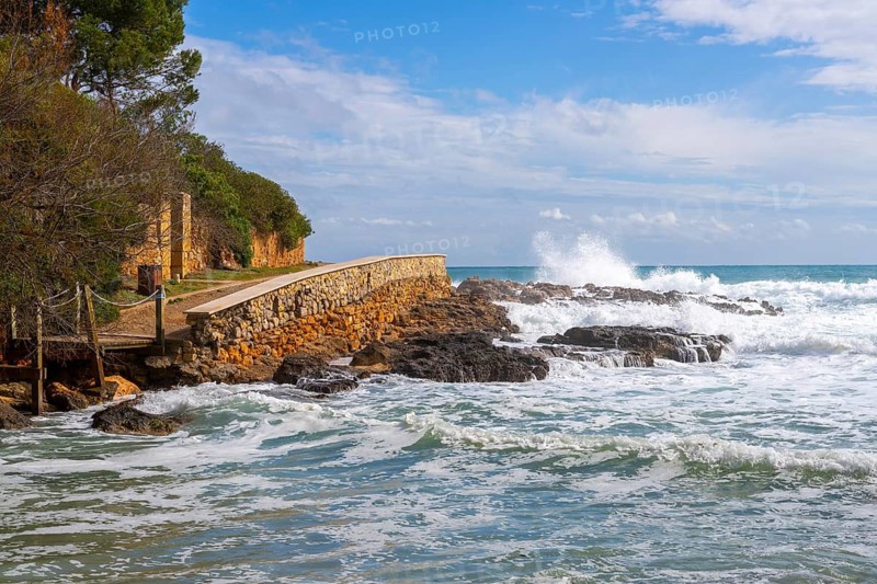 Wooden walkway destroyed by the sea, east coast in Cala Ratjada, Majorca, Spain