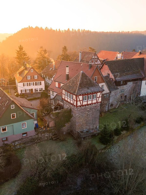 Historic half-timbered houses and a tower in a peaceful village at sunset, Zavelstein, district of Calw, Black Forest, Germany