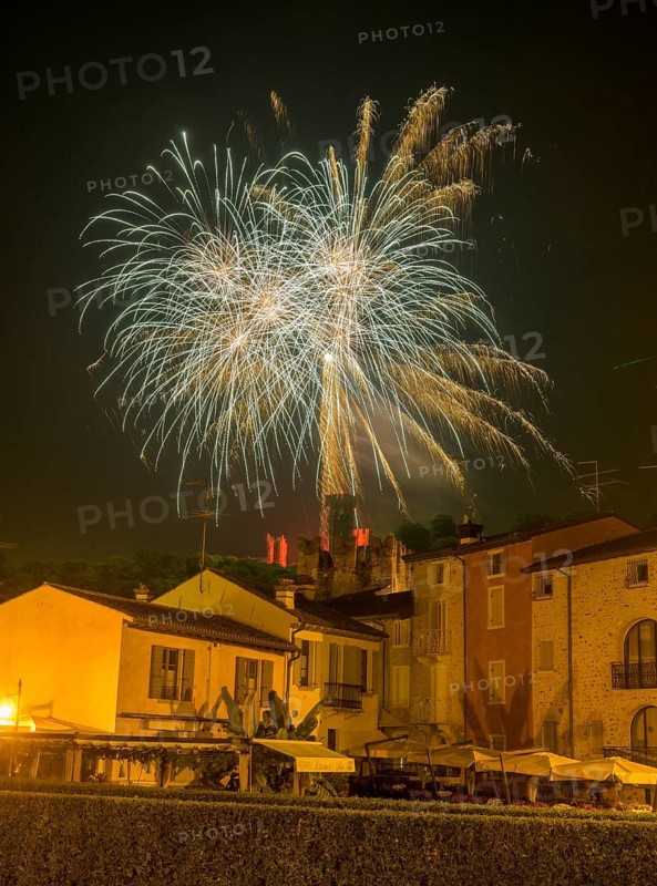 Fireworks from the Scaliger castle in the foreground Houses of, Borghetto, Valeggio sul Mincio, Province of Verona, Italy