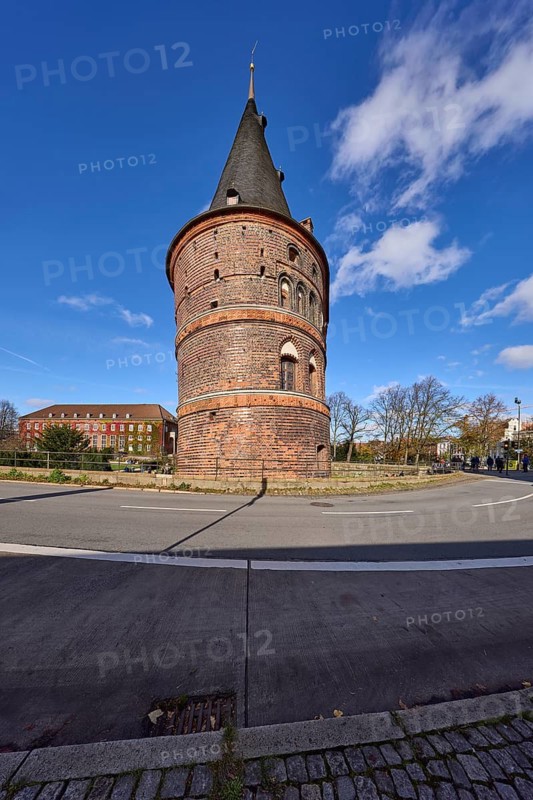 Lübeck Holstentor, side view, blue sky with fair weather clouds, street Holstentorplatz, Hanseatic city of Lübeck, independent city, Schleswig-Holstein, Germany