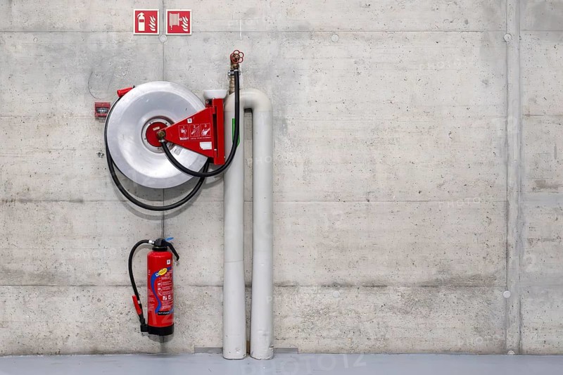 Symbolic photo of fire extinguisher and water hose, Bern, Switzerland