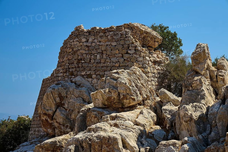 Powerful rock formations surrounded by stone ruins in a deserted landscape, Lost Place, Abandoned Village, Micro Chorio, Church of the Assumption of Mary, Zero Waste Island, Tilos, Dodecanese, Greek Islands, Greece