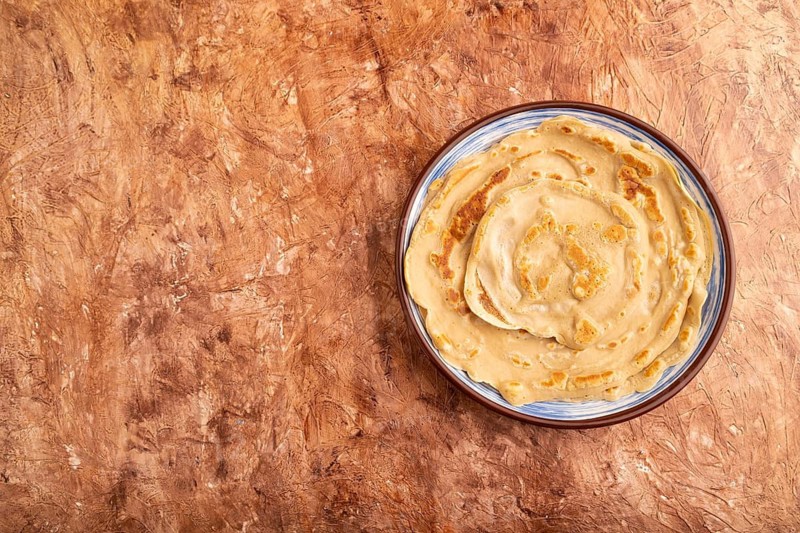 Stack of Plain Fried pancakes on brown concrete background. top view, flat lay, copy space