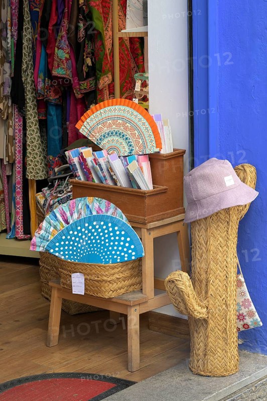 Corner of a shop with colorful patterned drawers, textiles and a decorative hat color cactus, Cordoba, Spain