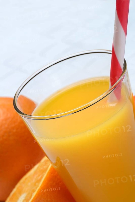 Orange juice in glass and orange