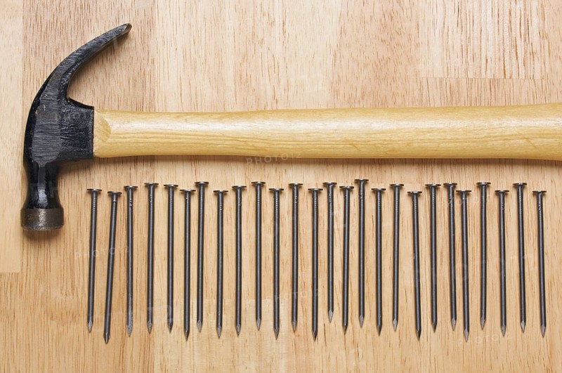 Hammer and Nails Abstract on Wood Background
