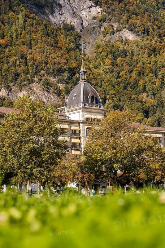 Historic building with tower against an autumnal mountain backdrop, Lake Brienz, Interlaken, Switzerland