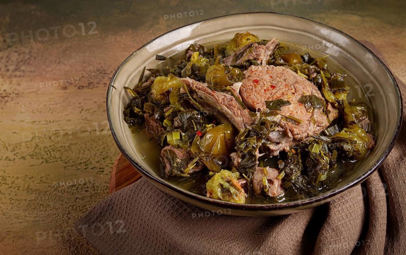 Chakapuli, Georgian dish, stewed meat with herbs and tkemali, in white wine, homemade, no people
