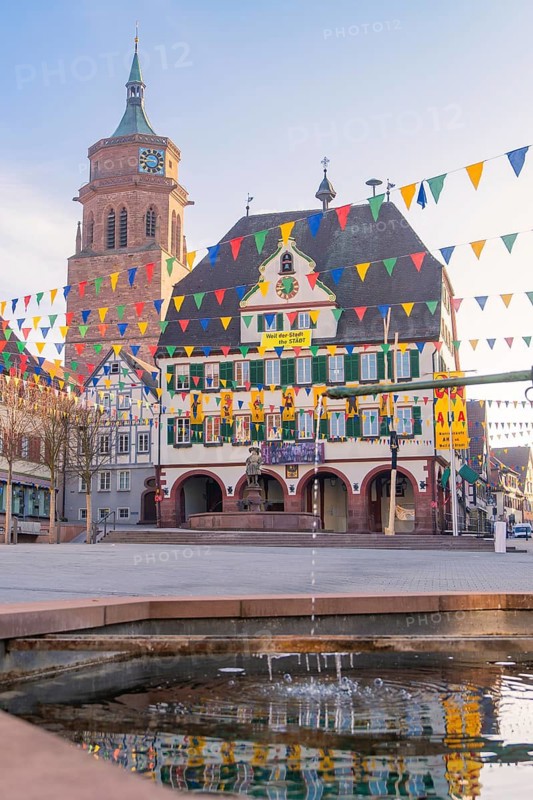 Square with bell tower and colourful pennants that convey a peaceful city atmosphere, Fasnet, Weil der Stadt, Böblingen district, Germany