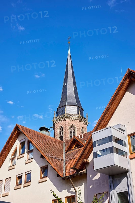 Church tower of St. Nikolaus, residential building, pointed roof with red roof tiles, frog perspective, blue sky, Kappelrodeck, Black Forest, Ortenaukreis, Baden-Württemberg, Germany
