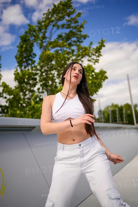 Confident beauty caucasian young woman dancing freestyle urban music in a urban park
