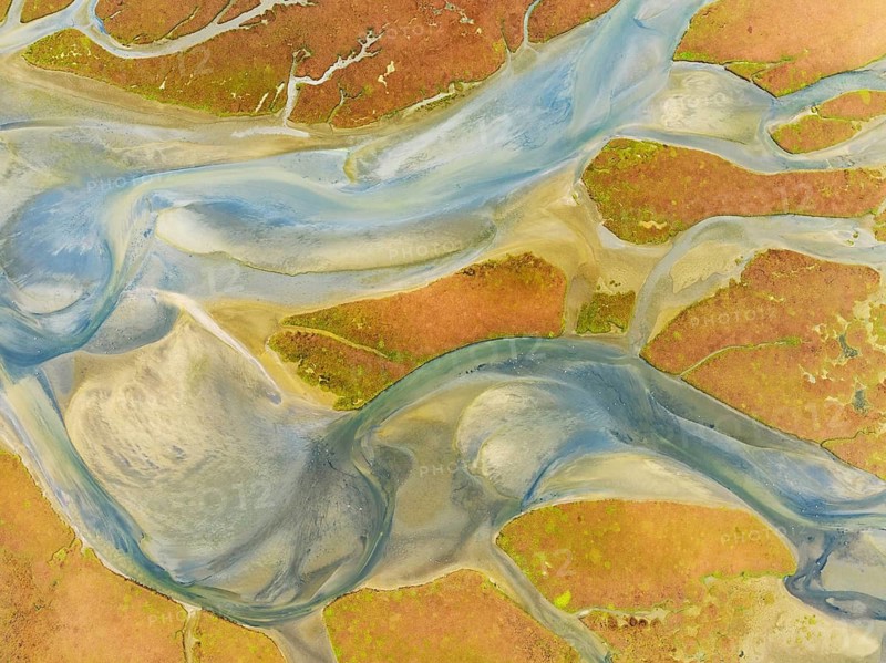 Streams at low tide in the marshland of the Walvis Bay lagoon. Aerial view. Drone shot. Walvis Bay, Namibia