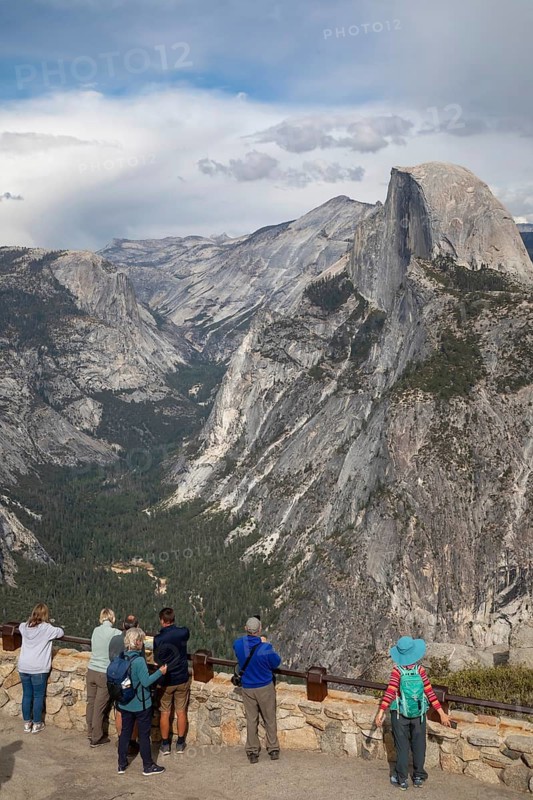 Yosemite National Park, California - Tourists view Half Dome in Yosemite National Park from Glacier Point