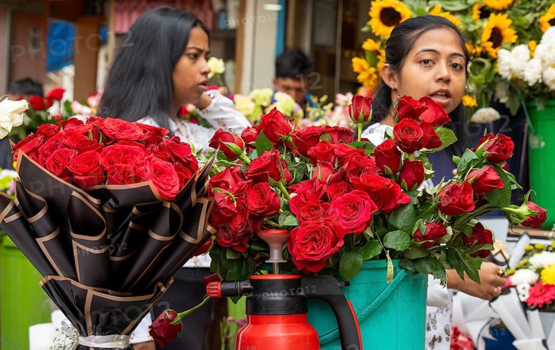 Customers browse red roses and other flowers at a roadside flower shop on Valentine's Day, in Guwahati, India on 14 February 2026