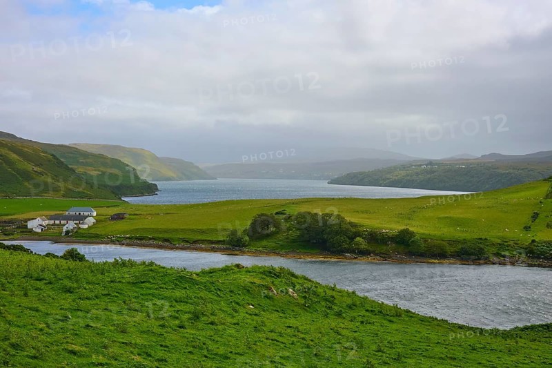 Idyllic green landscape with river, lake and a farmhouse under cloudy sky, Isle of Skye, Scotland, United Kingdom, Great Britain