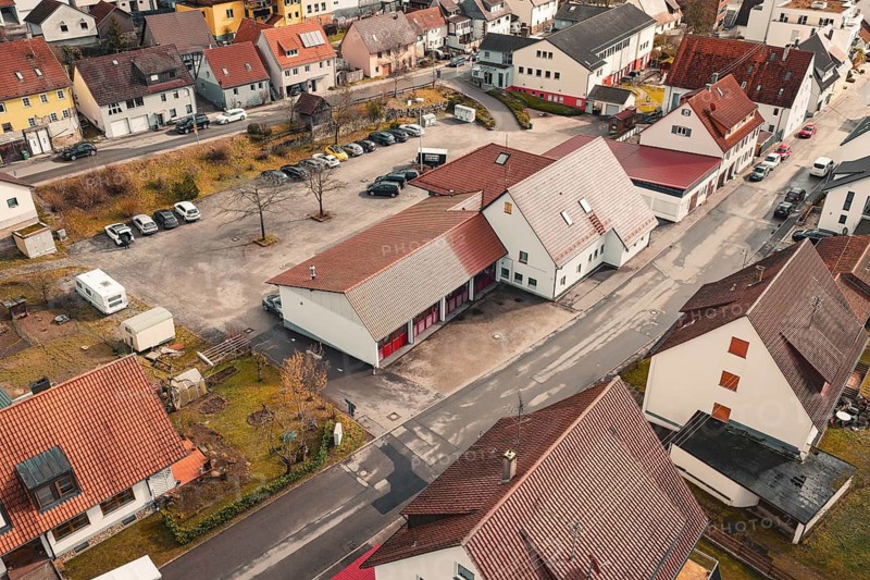 Residential buildings in a village with red tiled roofs, quiet atmosphere and roads in autumn surroundings, fire station, Gechingen, Calw district, Germany