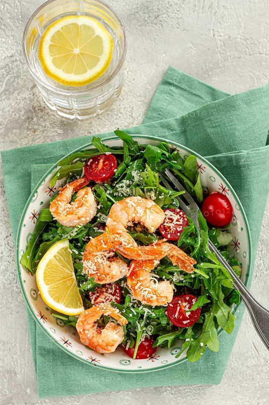 Shrimp salad with arugula and cherry tomatoes, with parmesan cheese, healthy food