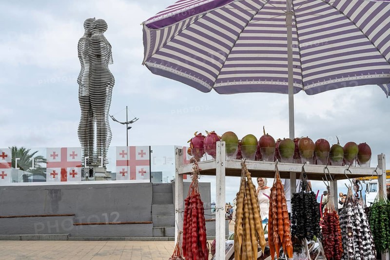 Batumi, Georgia. July 21st 2025. A street stall selling Churchkhela, a popular sweet snack made of nuts threaded on string and dipped in grape juice being sold beside the Ali and Nino art installation