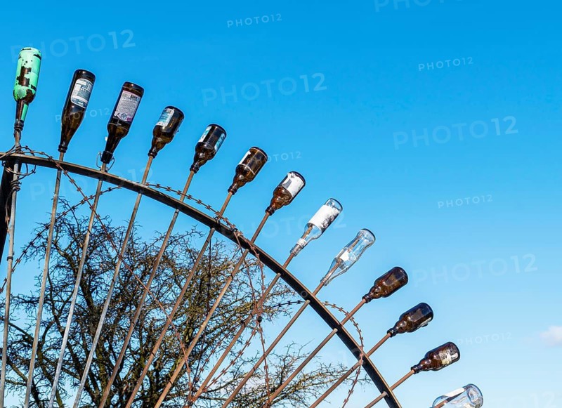 Discarded glass beer bottles on the steel tips of a barrier, Steinwerder, Hamburg, Germany