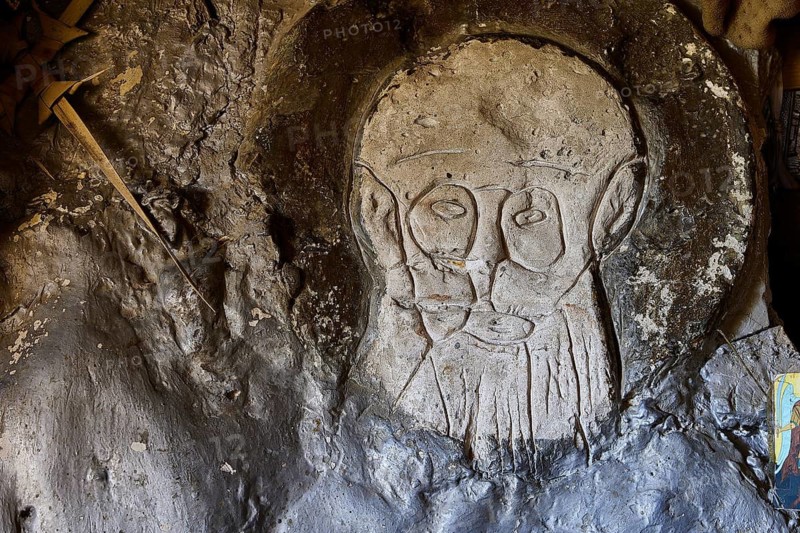 Face carved into the cave wall in the form of a stone relief, chapel, Agios Nikolaos, rock chapel, Oasis Beach, east coast of Rhodes, Rhodes, Dodecanese, Greek Islands, Greece
