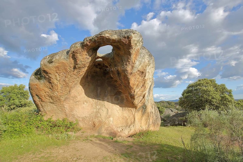 Pointed red rock with hole, bizarre rock formation, large boulder, Los Barruecos, Malpartida de Caceres, Extremadura, Spain