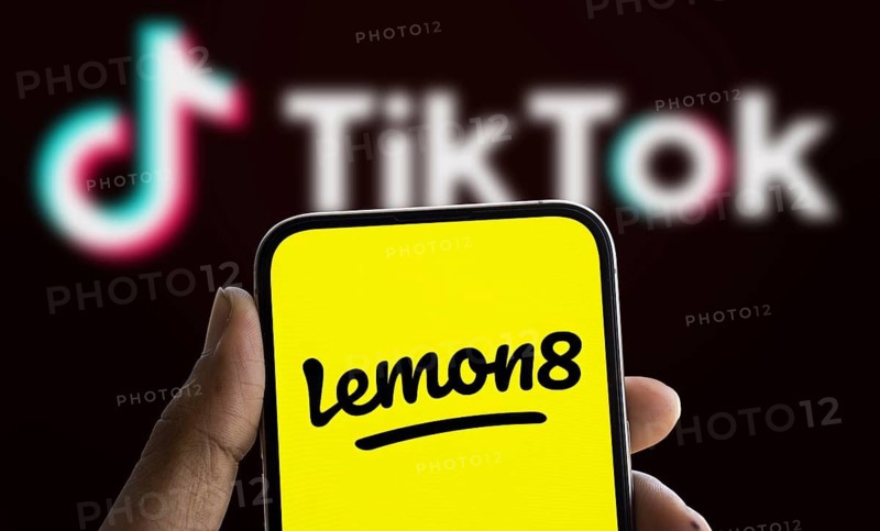 Lemon8 logo is displayed on smartphone and Tiktok logo in the background. Lemon8 is a social media app
