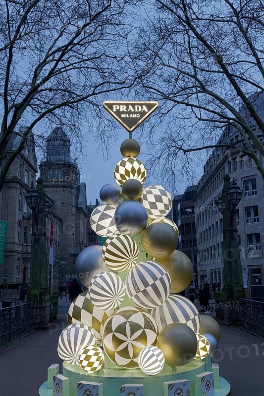 Designer Christmas tree of the Italian luxury brand Prada on a bridge over the Kö-Graben, twilight.Königsallee, Düsseldorf, North Rhine-Westphalia, Germany