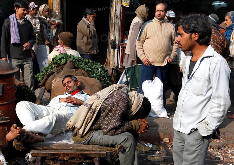 New Delhi, India, 14.01.10 - Market scene, day labourers resting on a sack truck, India