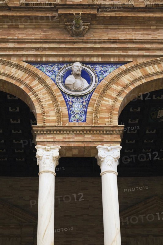 Bust of Hernan Cortes and painted ceramic tiles on arched brick and stone structure, Plaza de Espana, Maria Luisa Park, Seville, Spain