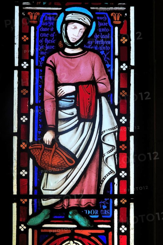 Stained glass lancet window picture of Dorcas, Church of Saint Mary, Uggeshall, Suffolk, England, UK