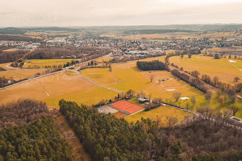 Extensive landscape with fields and forest, bordered by a village in the background, under cloudy sky, Ötisheim, Enzkreis, Germany