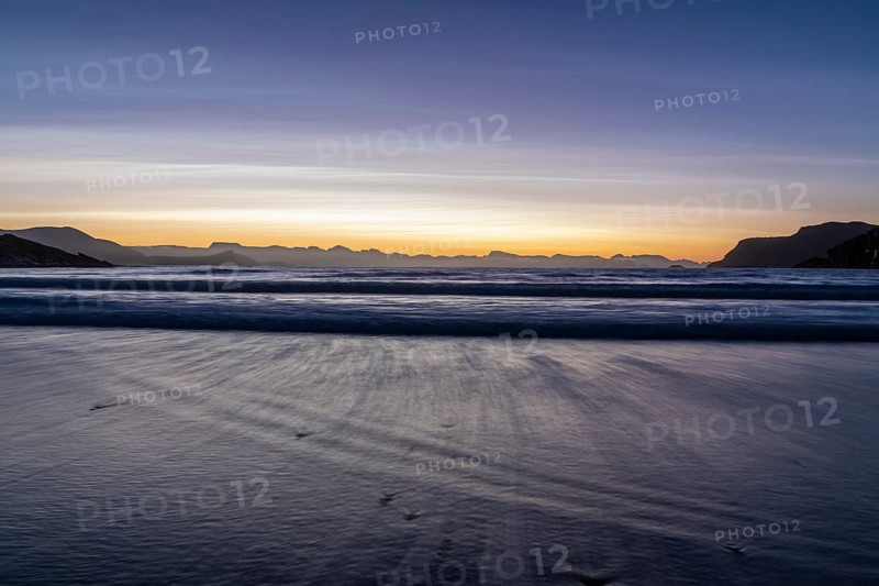 Ocean surf in sandy bay on the Norwegian European Sea at dusk, Söröya, Finnmark, December 2018