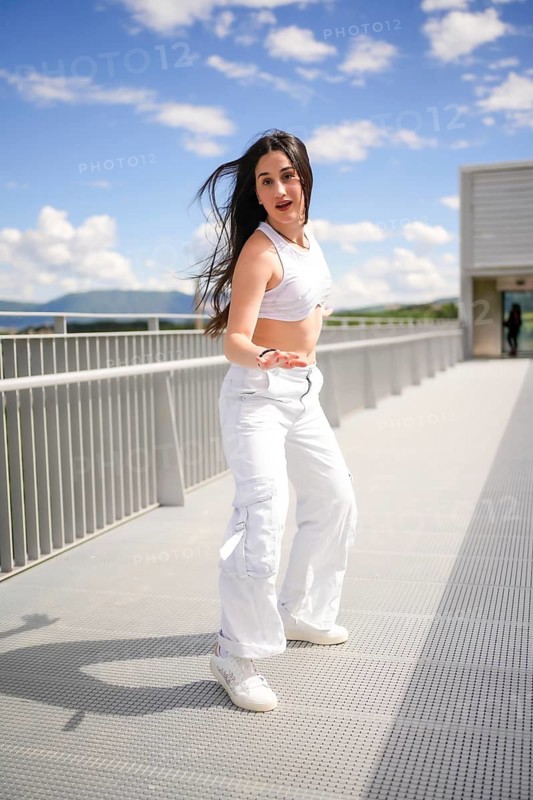 Vertical full length of a caucasian beauty young woman moving dancing urban music