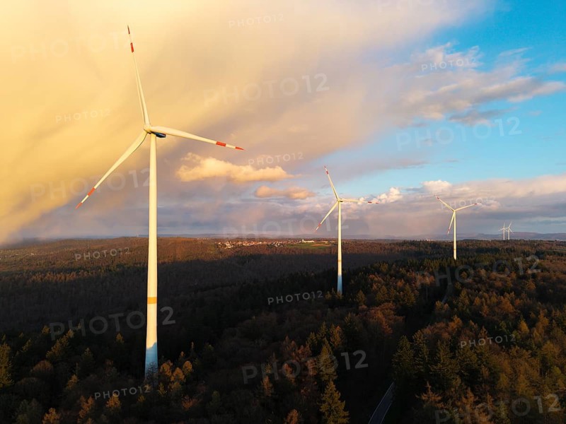 Wind turbines stand high above treetops as clouds gather in the sky, wind turbine, near Schorndorf-Winterbach, Baden-Württemberg, Germany