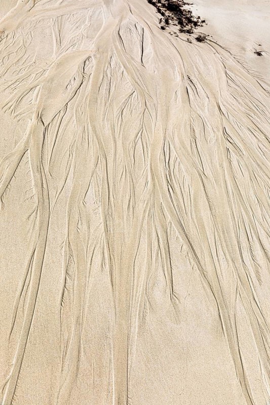 Seawater run-off leaves traces in the sand on Fazayat beach in Al Hauta, Dhofar province, Arabian Peninsula, Sultanate of Oman