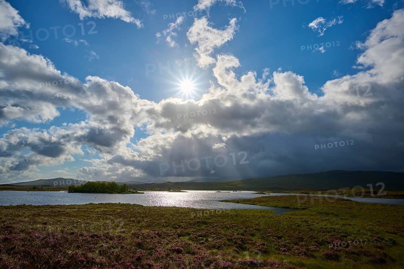 Sun shines behind clouds over river in a wide natural landscape, Rannoch Moor, Bridge of Orchy, Scotland, United Kingdom, Great Britain