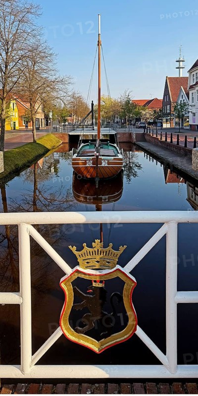 City coat of arms with open-air shipping museum on the main canal, museum ship Frisian Tjalk Thekla of Papenburg, Lower Saxony, Germany