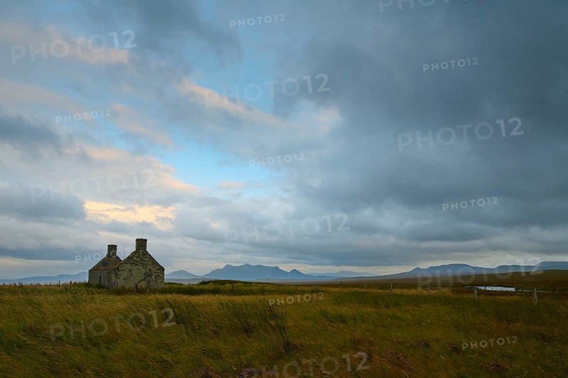 Stone house in a vast landscape at dusk under a cloudy sky, Moine House, Lairg, Scotland, United Kingdom, Great Britain