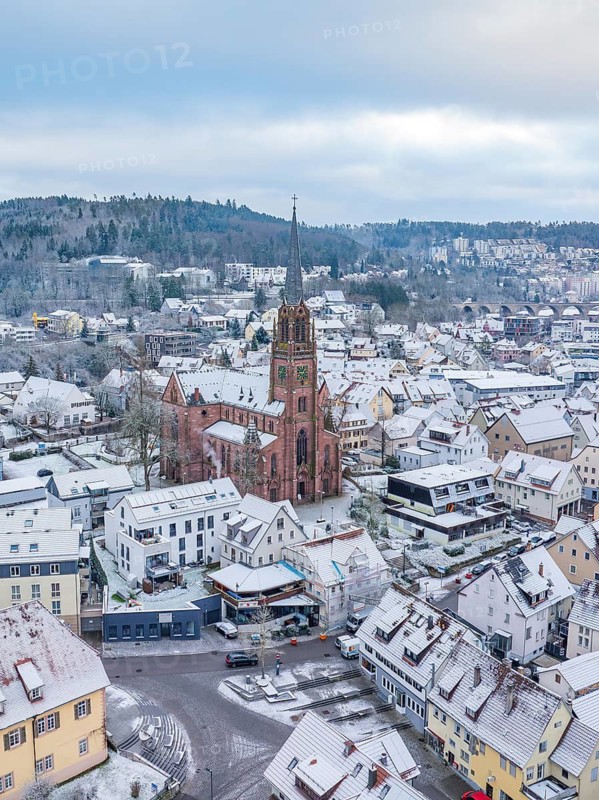Snow-covered town with church in the centre, surrounded by houses, Nagold, Black Forest, Germany